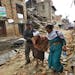 An elderly injured woman is taken to her home after treatment in Bhaktapur near Kathmandu, Nepal, Sunday, April 26, 2015. A strong magnitude earthquak