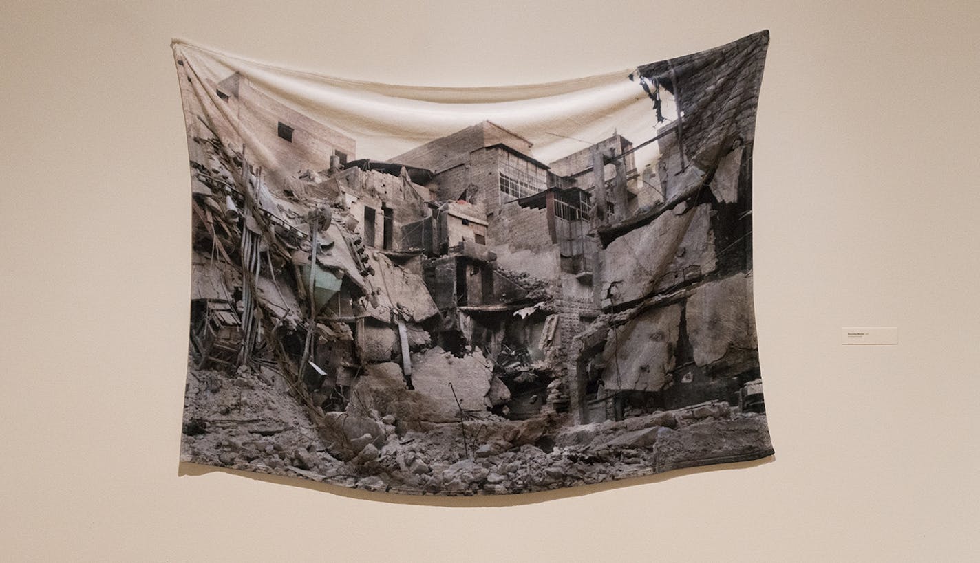 "Receiving Blanket," a plush blanket imprinted with a bombed-out building, is part of Essma Imady's exhibit "Thicker Than Water."