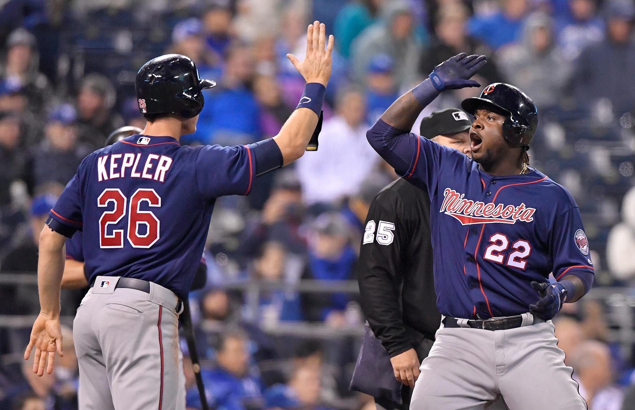 The Minnesota Twins' Miguel Sano (22) celebrates scoring with Max Kepler on a double by Joe Mauer in the eighth inning against the Kansas City Royals at Kauffman Stadium in April