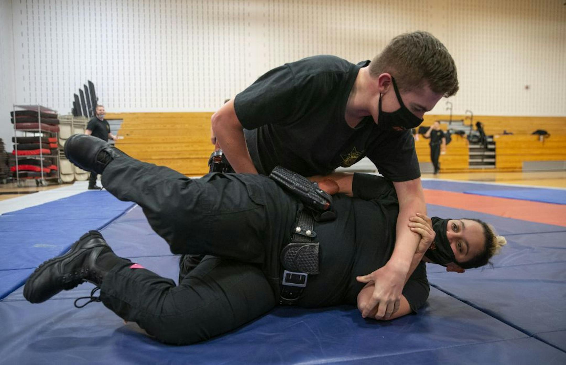 (Top) Collin O'Toole practiced proper ground fighting technique with Mona Zeidan during defensive tactics class at Fond Du Lac Tribal and Community College in Cloquet, Minn. on Tuesday November 17, 2020.