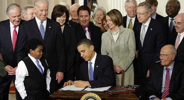 FILE - In this March 23, 2010 file photo, President Barack Obama signs the health care bill in the East Room of the White House in Washington. Here&#x
