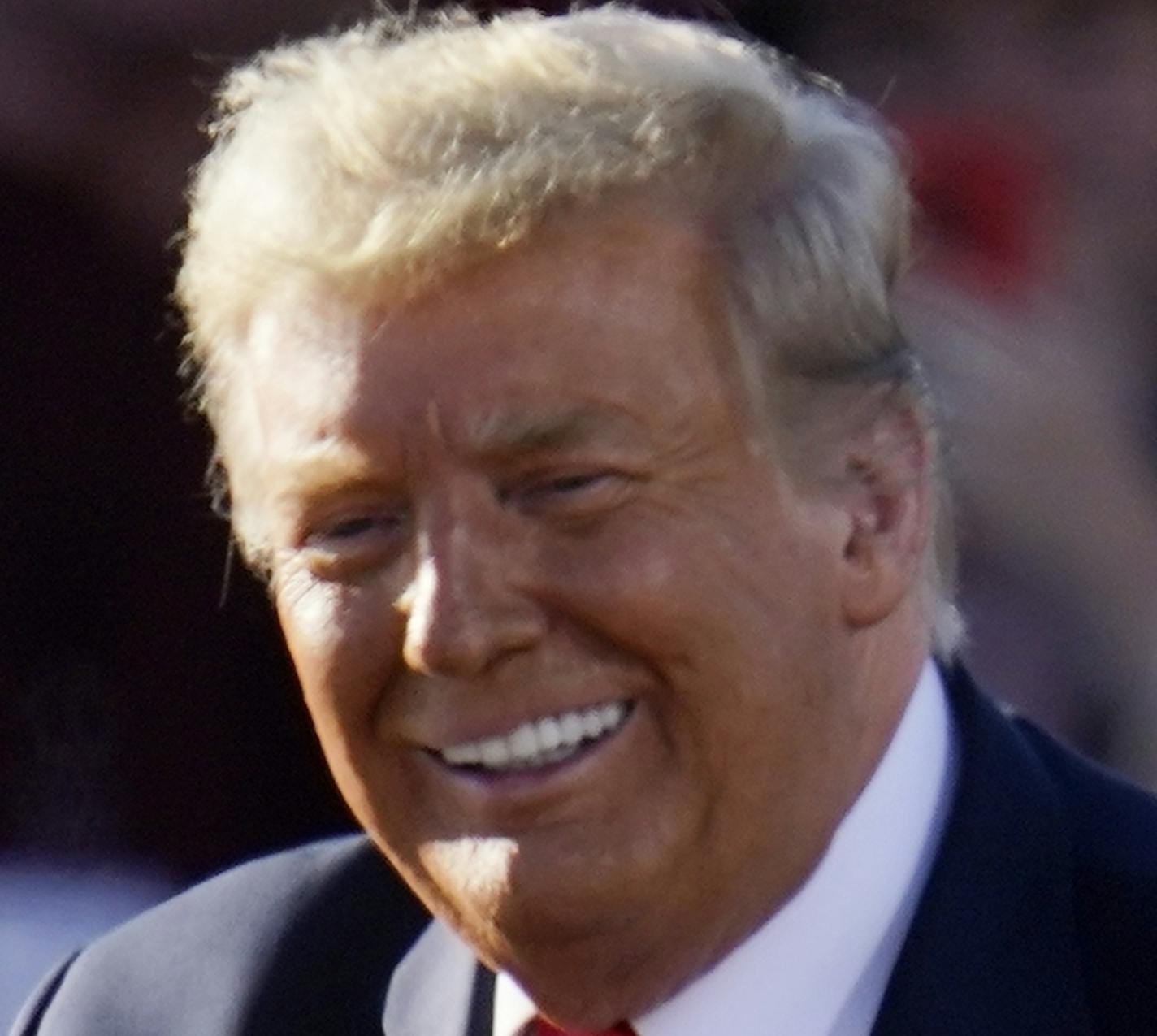 President Donald Trump smiles at supporters at a campaign rally at Phoenix Goodyear Airport Wednesday, Oct. 28, 2020, in Goodyear, Ariz. (AP Photo/Ross D. Franklin)