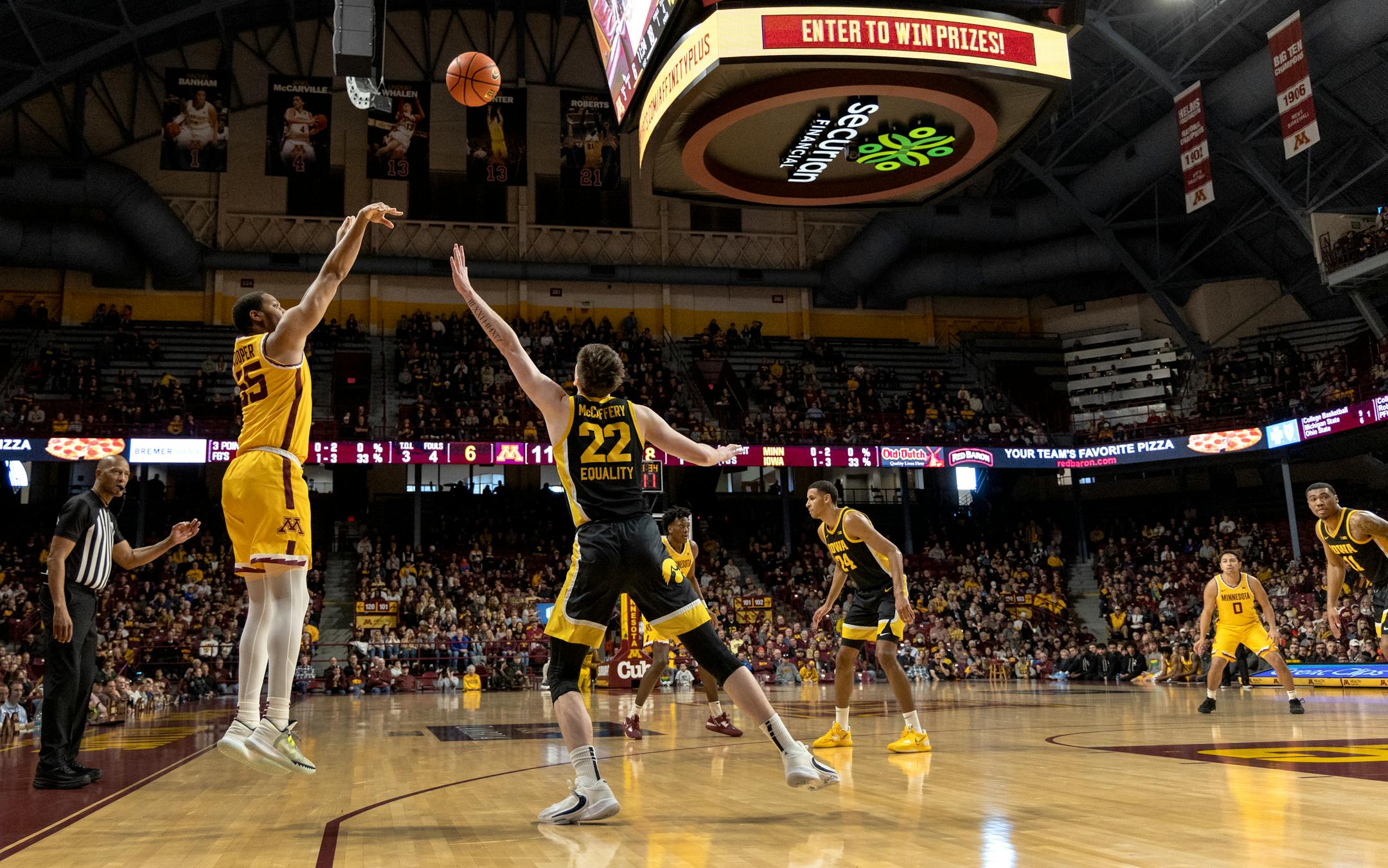 Ta'Lon Cooper (55) of the Minnesota Gophers makes a three pointer in the first half.