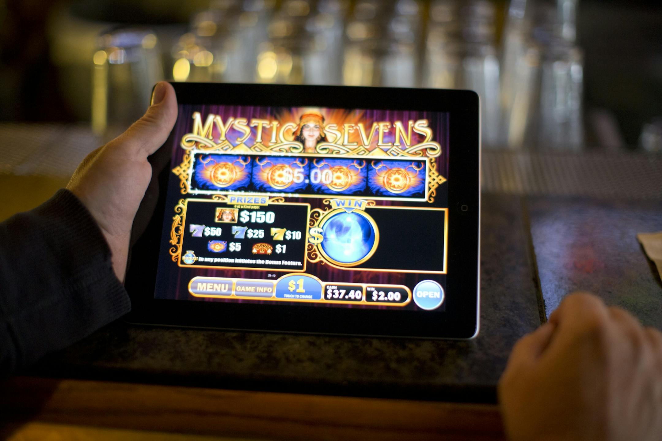 Electronic pulltab devices made their debut in Minnesota Tuesday, September 18, 2012 after receiving state approval. O'Gara's Bar and Grill in St. Paul, MInn. was among a handful of establishments that were operational Tuesday afternoon. Dick Kari won $5 while playing the new electronic pulltab game on an iPad at the bar at O'Gara's Tuesday afternoon. He owns a bar in Proctor, Minn. "I'll be getting one of these next week. These things are neat, I'll tell you!" he said.