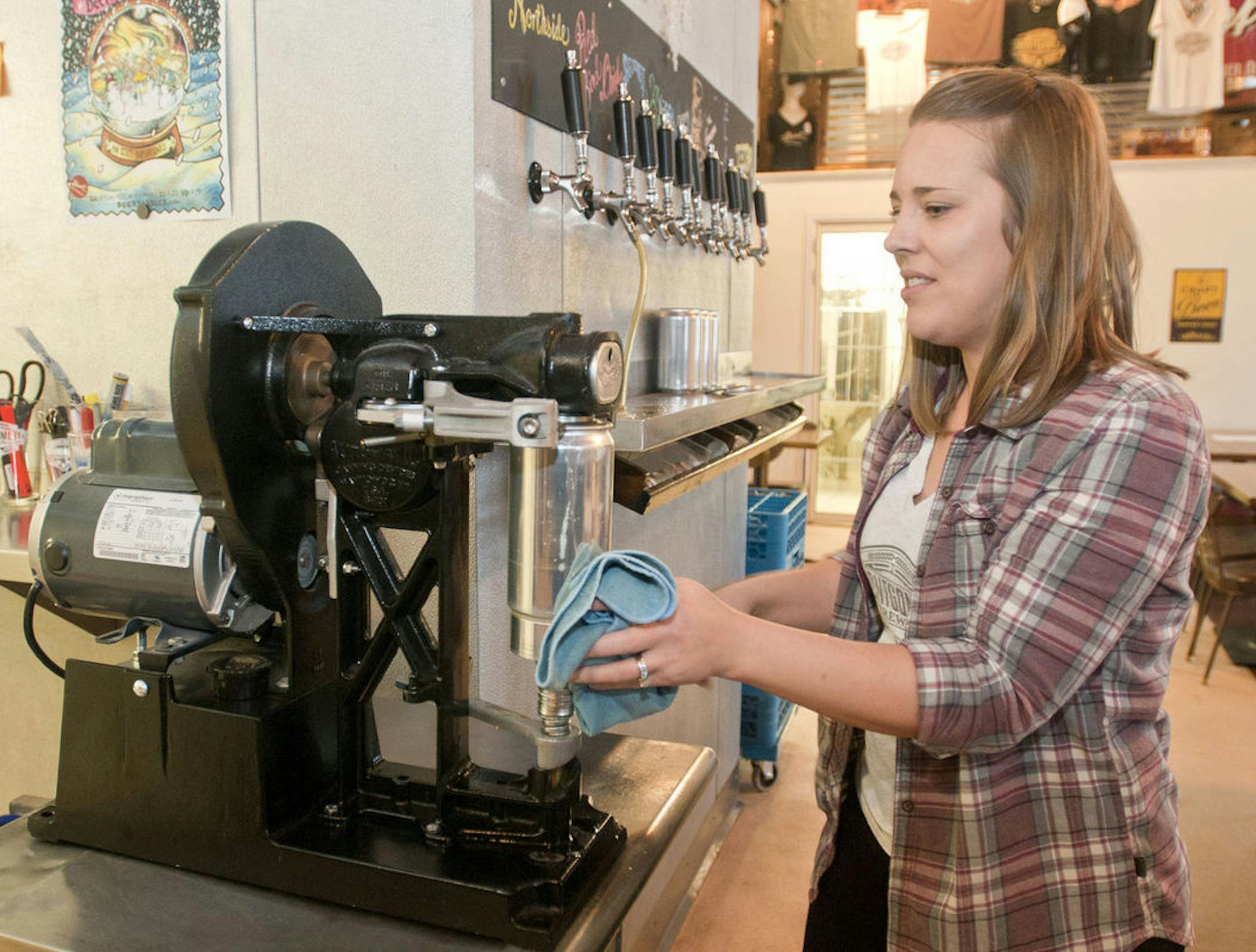 Jamie Stasney wipes moisture off of a cannon, a large take-home beer container, at the Montgomery Brewing Company. The brewery celebrated its second anniversary in late December
