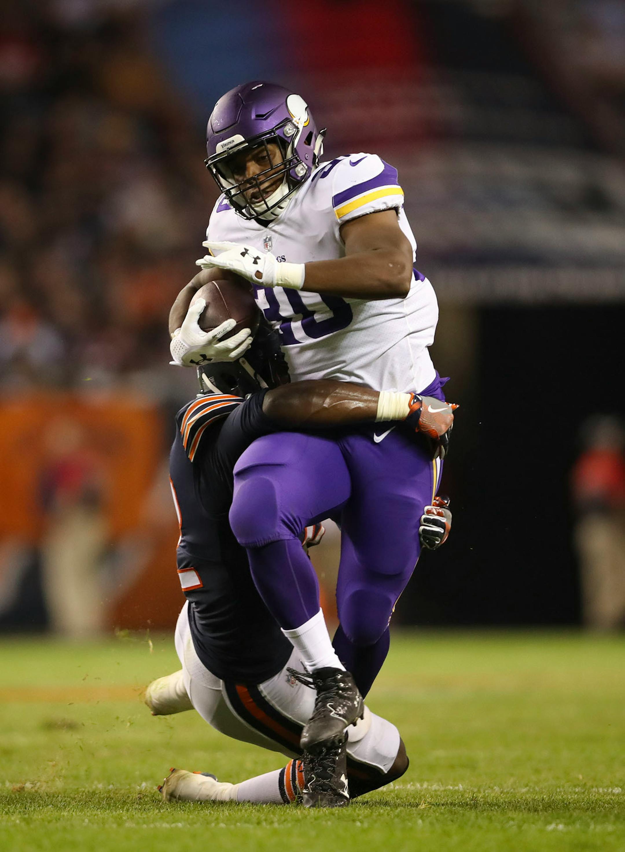 Minnesota Vikings running back C.J. Ham (30) gained 11 yards and set up a third quarter touchdown before being brought down by Chicago Bears inside linebacker Christian Jones (52).