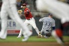 Kansas City Royals catcher Nick Dini (33) was out at second as Minnesota Twins shortstop Jorge Polanco (11) was unable to turn the double play off a s