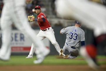 Kansas City Royals catcher Nick Dini (33) was out at second as Minnesota Twins shortstop Jorge Polanco (11) was unable to turn the double play off a s