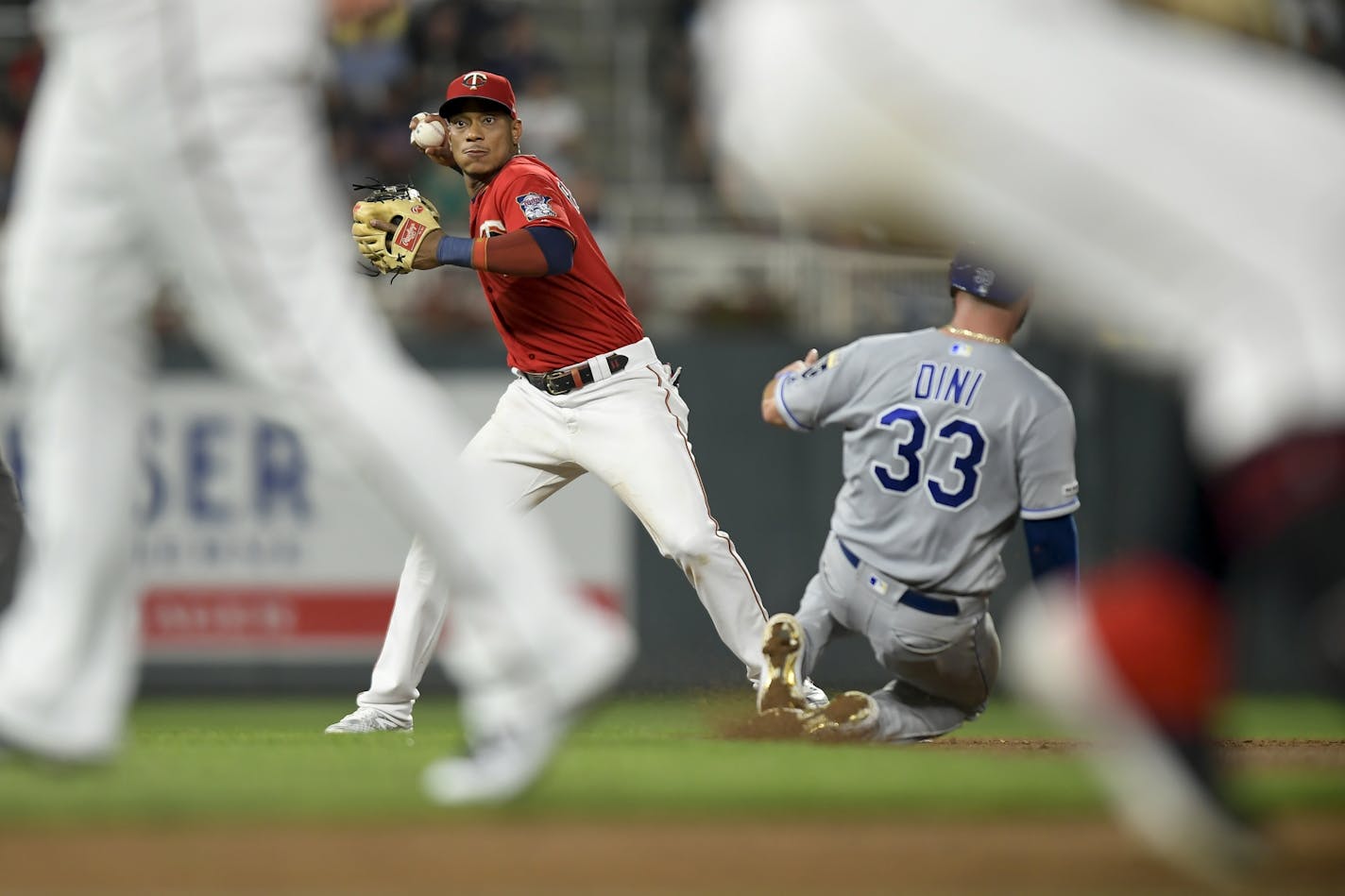 Kansas City Royals catcher Nick Dini (33) was out at second as Minnesota Twins shortstop Jorge Polanco (11) was unable to turn the double play off a single hit by Kansas City Royals shortstop Adalberto Mondesi (27) in the top of the third inning Friday night.