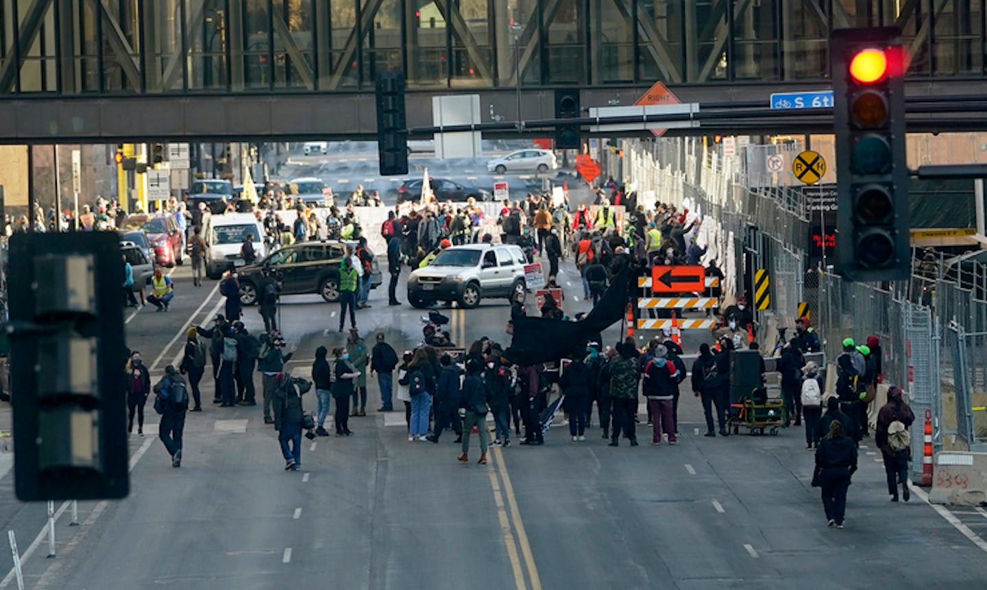 Protestors gather on 3rd Avenue on the north side of the Hennepin County Government Center before marching as the trial of fired Minneapolis police of