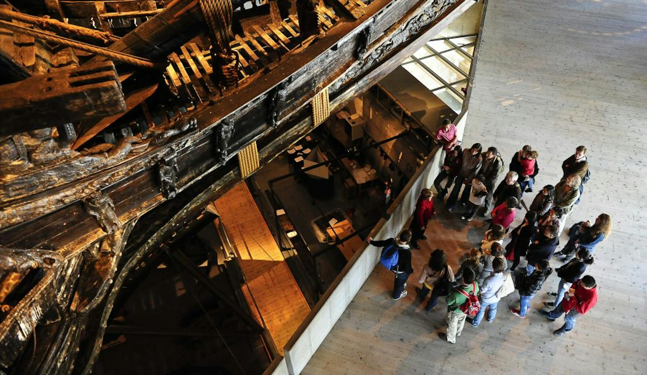 A group of tourists listen to their guide as they stand next to the royal warship Vasa at the Vasamuseet museum in Stockholm, Sweden. The country's 's most famous maritime discovery is housed in a popular museum where visitors can admire the ship's details, down to the flashing teeth of the carved lions that adorn its elaborate exterior. The Vasa was raised from the Stockholm harbor in 1961, 333 years after it sank on its maiden voyage.