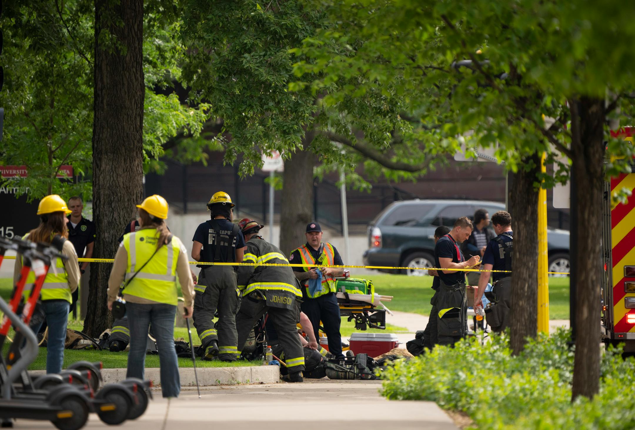 Minneapolis Fire Department personnel rested in the shade on University Ave. near where the suspected gas leak was first reported Thursday afternoon in Minneapolis. A suspected gas leak resulted in the evacuation of fraternity houses on University Ave. SE across from the U of M campus.