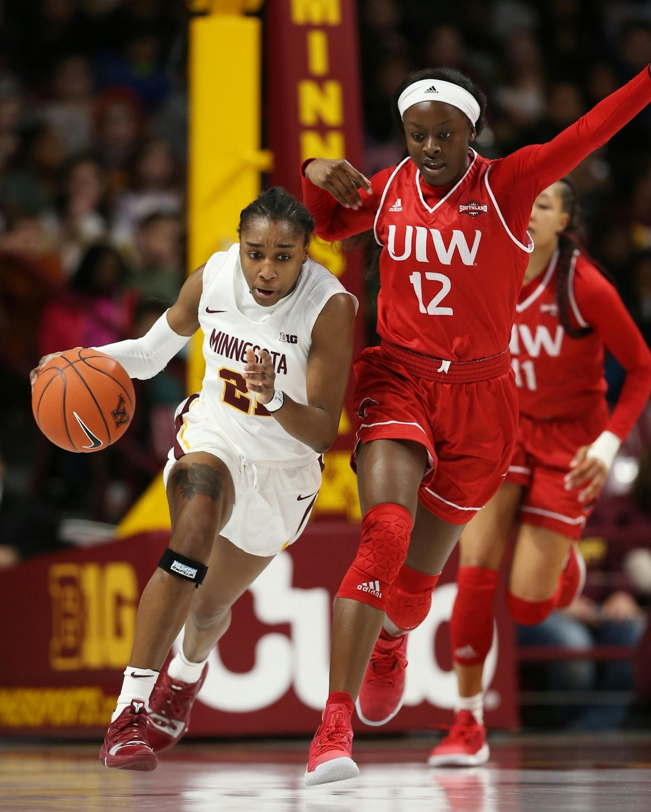 Angelica Wiggins(12) tries to slow down the progress of Gophers Jasmine Brunson