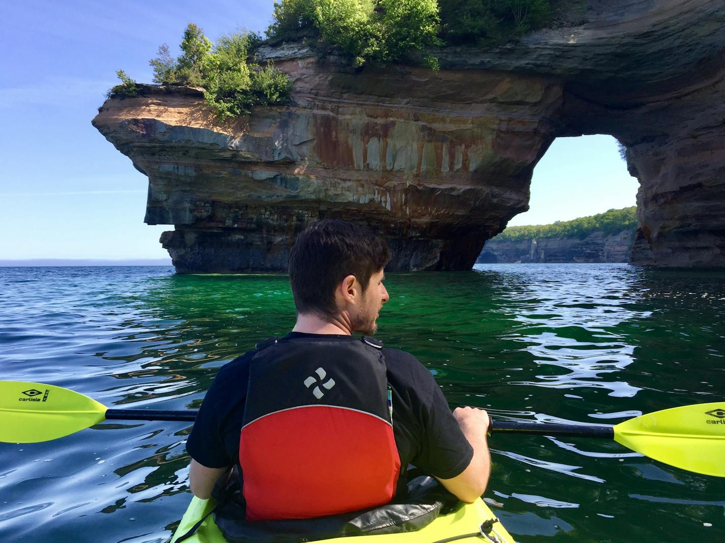 Kayakers paddle along Pictured Rocks National Lakeshore in Michigan, along the south shore of Lake Superior — one of the highlights along the 1,300-mile Lake Superior Circle Tour. (I think this is a photo by Kelly Smith —spg)