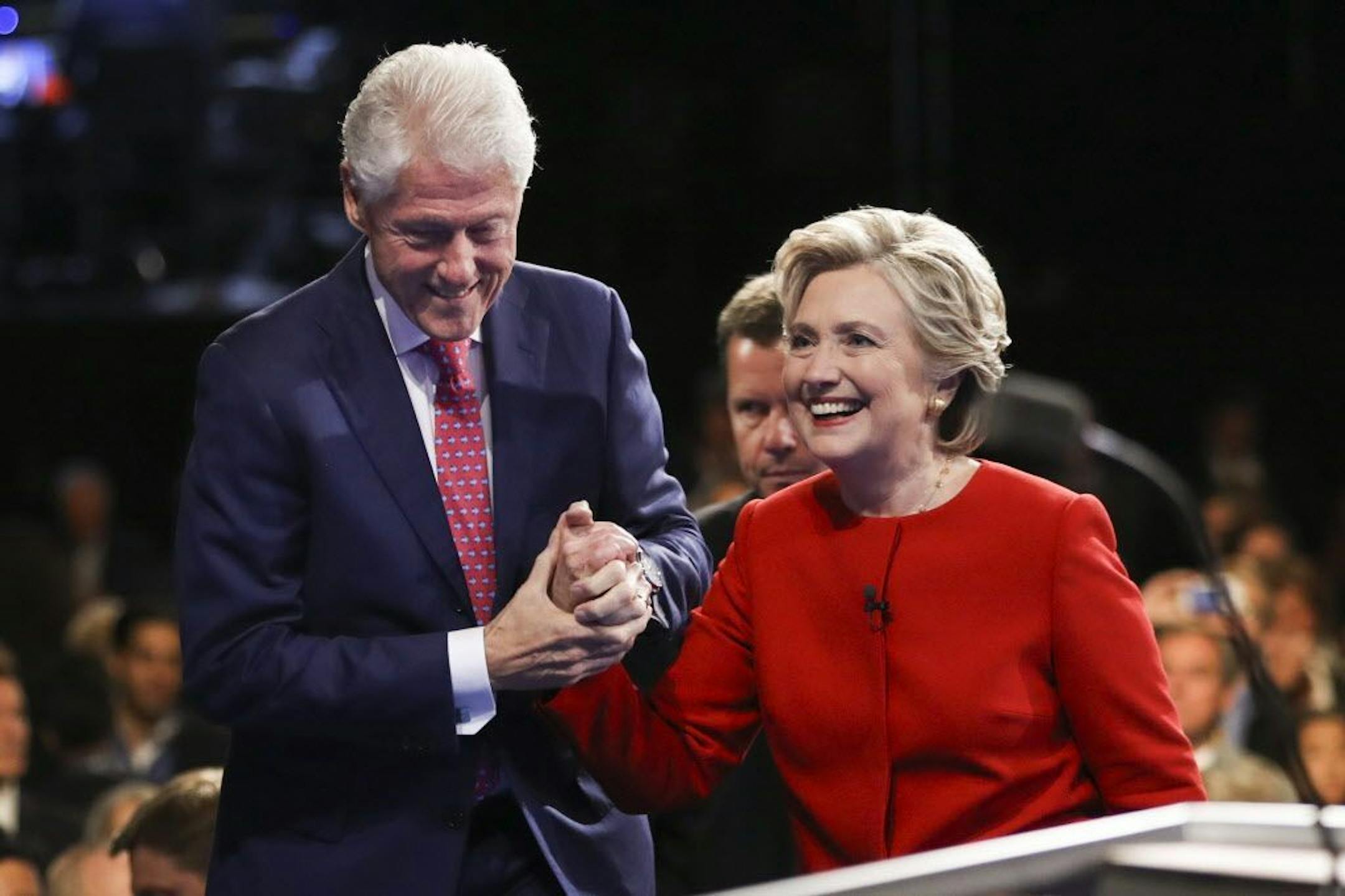 Democratic presidential nominee Hillary Clinton walks off the stage with her husband former President Bill Clinton after the presidential debate with Republican presidential nominee Donald Trump at Hofstra University in Hempstead, N.Y., Monday, Sept. 26, 2016.