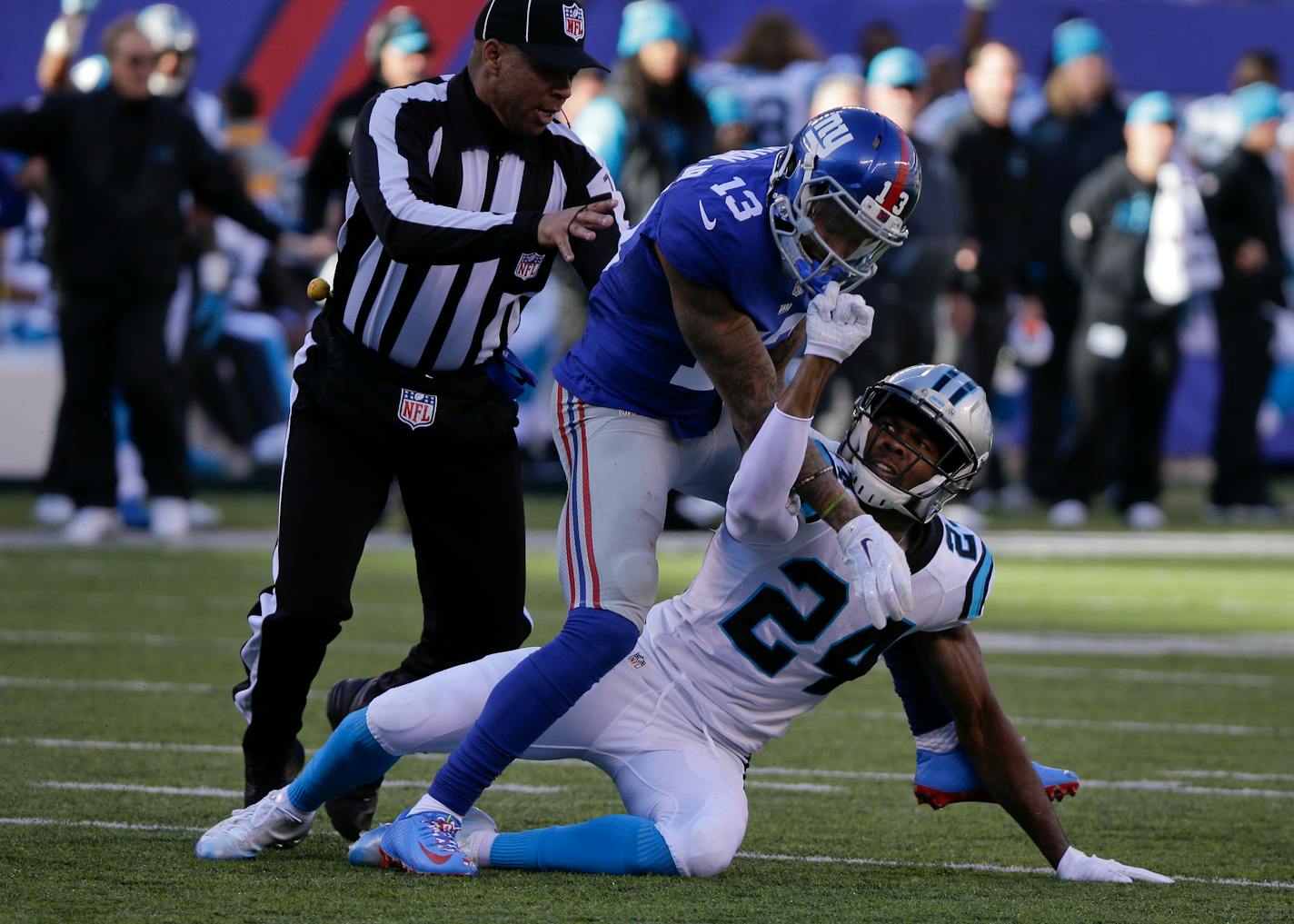 A referee steps in to separate New York Giants wide receiver Odell Beckham (13) and Carolina Panthers' Josh Norman (24) as they scuffle during the first half of an NFL football game Sunday, Dec. 20, 2015, in East Rutherford, N.J. (AP Photo/Julie Jacobson)