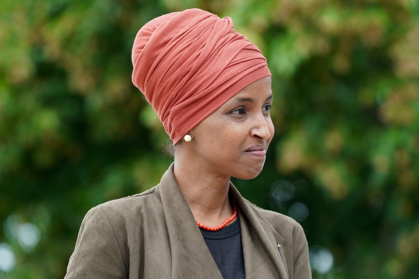 Surrounded by local elected officials and community leaders, Rep. Ilhan Omar speaks to the media, making her case for re-election on Wednesday, August 5, 2020 outside DFL headqurters in St. Paul, Minnesota. (Glen Stubbe/Minneapolis Star Tribune/TNS) ORG XMIT: 1738873