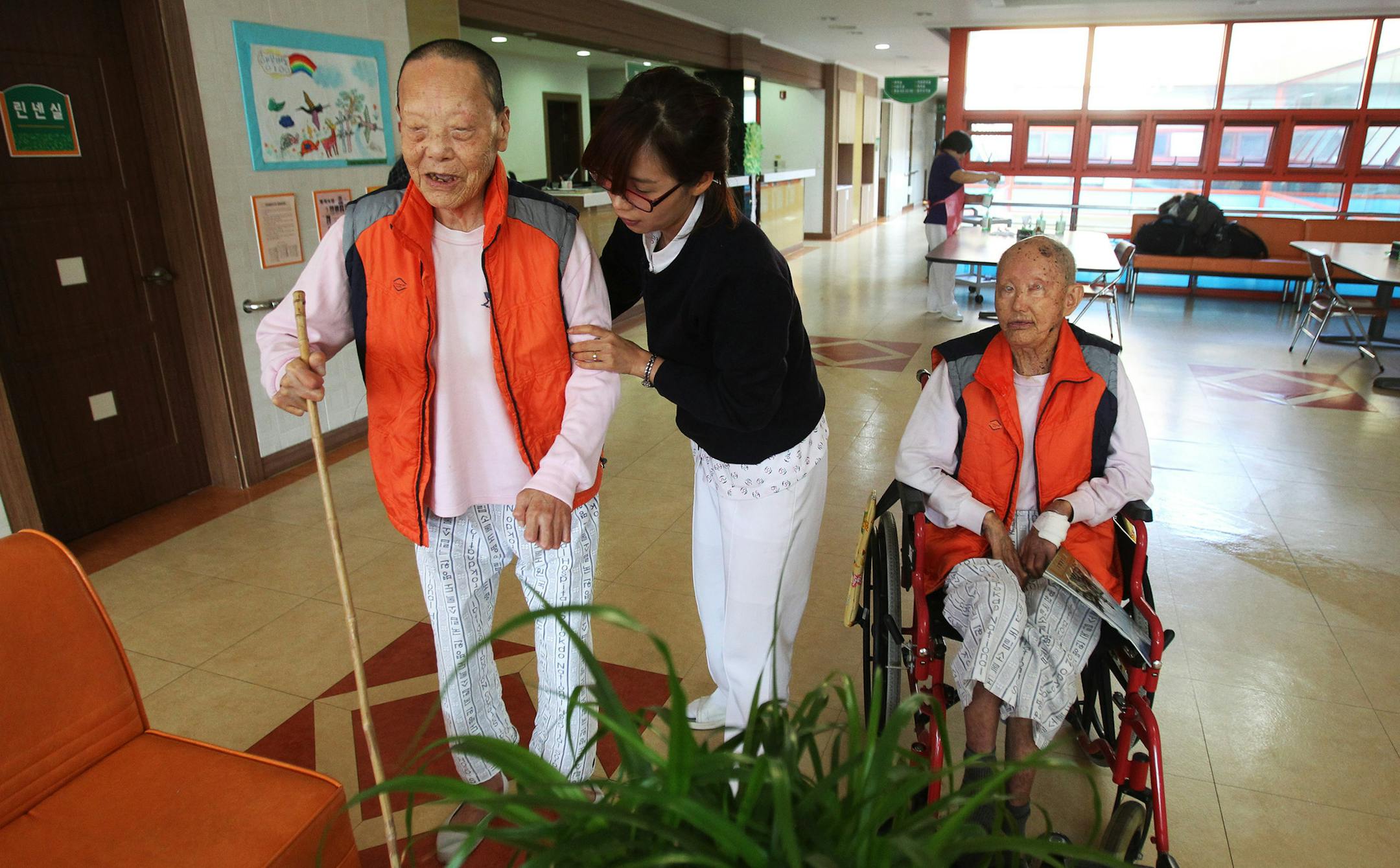 A nurse helped former leprosy patients at Sorokdo National Hospital on Sorok Island, South Korea. Until a few decades ago, leprosy sufferers faced beatings, separation from their children, harsh labor, forced sterilizations and abortions. Today, it is a refuge for former patients in their old age.
