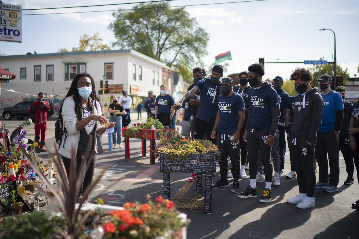 Timberwolves players, coaches, and staffers listened to Jeanelle Austin, left, as she explained and interpreted the memorial site for the group. The four players in the foreground are, from left, the Timberwolves' Jarred Vanderbilt, Jordan McLaughlin, and Jaylen Nowell, and at right is Lindell Wigginton, a former Iowa State player who now plays in the Israeli Premier League. ] JEFF WHEELER • jeff.wheeler@startribune.com Timberwolves players, coaches, and staff stopped to visit the George Floyd m