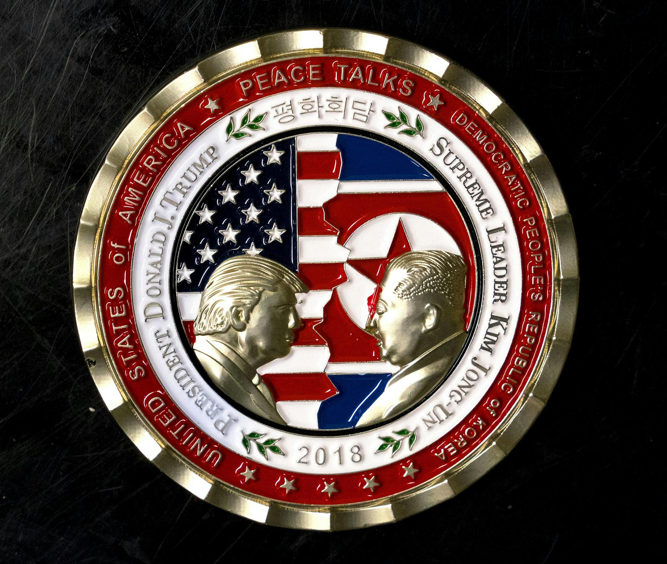 The White House coin for the planned summit between President Donald Trump and North Korean President Kim Jong-Un in Washington, May 21, 2018. Amid growing doubts about whether Trump will meet with Kim on June 12, the administration came under criticism Tuesday over commemorative coins that were created to honor the planned meeting. The coins, issued by the White House Communications Agency, a military unit assigned to the president, feature likenesses of the two leaders, referring to Kim as &#x