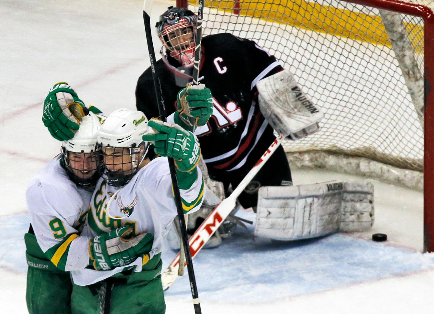 Edina's Cullen Munson (9) and Miquel Fidler celebrated the Hornets final goal of the game beating Panthers goalie Will DuPont in 3rd period action.