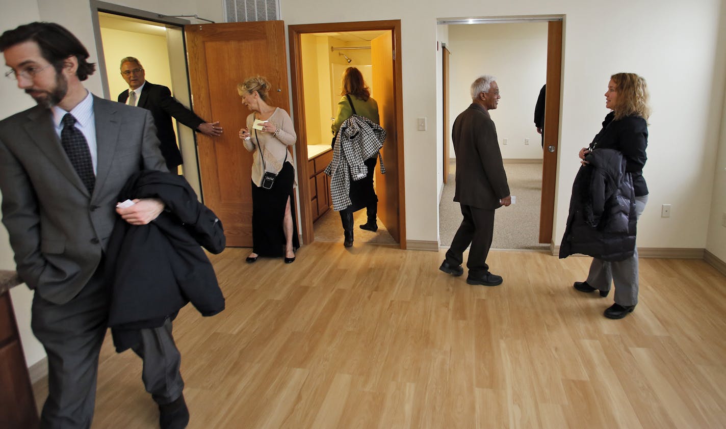 A group on tour is shown one of the apartments. ] The Abbott Apartment complex has been transformed from the old Abbott Hospital building in downtown Minneapolis. Developer Swami Palanisami led city officials and potential residents on a tour of the development. (MARLIN LEVISON/STARTRIBUNE(mlevison@startribune.com)