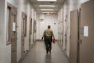 A deputy walked down the hallway of the intake area in the basement of the Hennepin County Jail.
