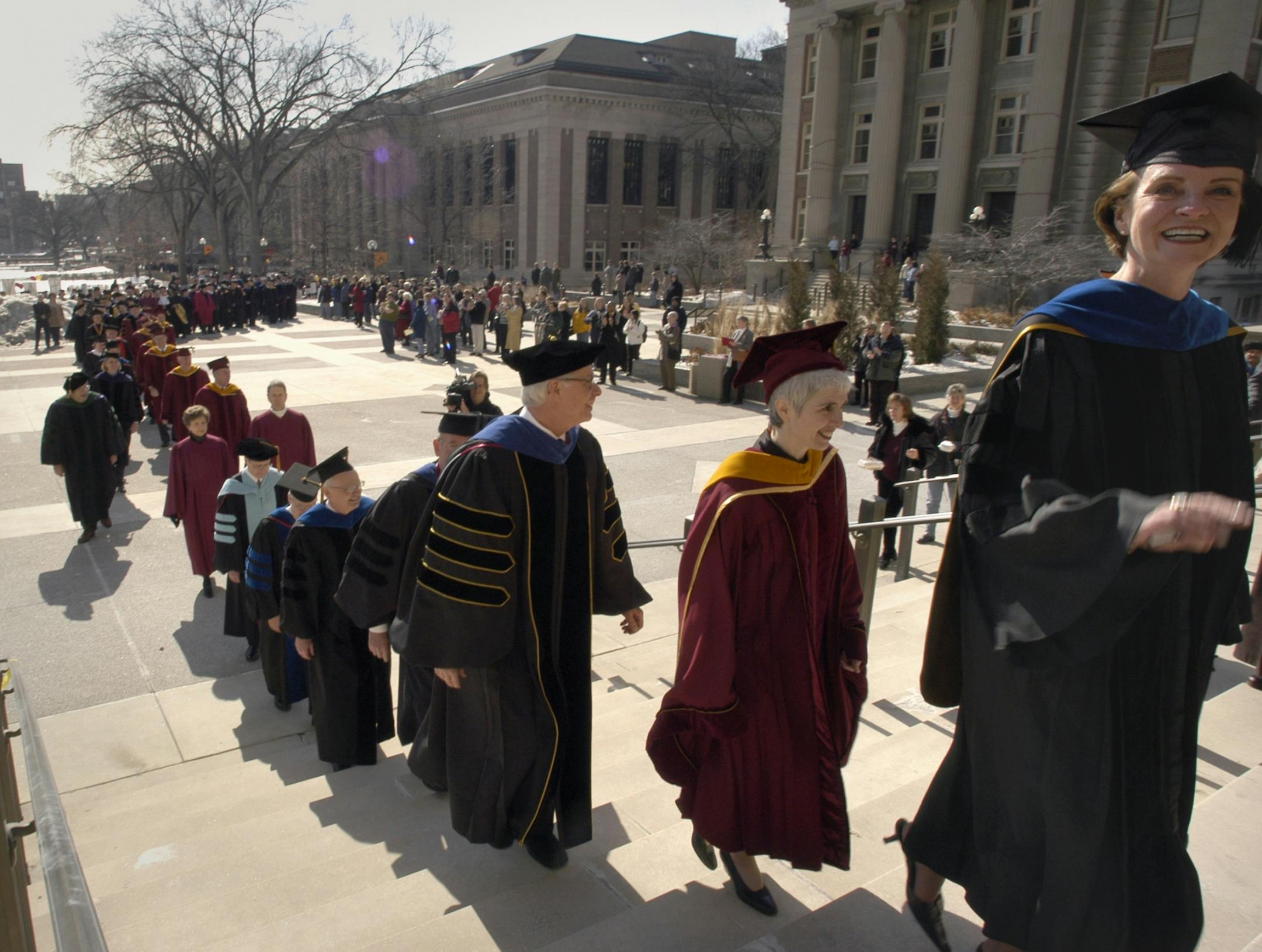 The procession started at Coffman Union and came up the steps of Northrup Auditorium. New President Bob Bruininks is third from the right; in front of him is Maureen Reed, chairman of the Board of Regents (red robe) and Bruininks' wife, Susan Hagstrum, far right. GENERAL INFORMATION: MINNEAPOLIS, MN. 2/28/2003:UNIV01: We'll have pageantry, protest and horn-blowing at the inauguration ceremonies for University of Minnesota President Bob Bruininks. Here's the schedule: 12:30: University employees