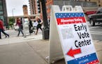 People walk from the Democratic-Farmer-Labor Party's early voting rally to a voting center in Minneapolis Friday, Sept. 23, 2016. Friday kicked off th