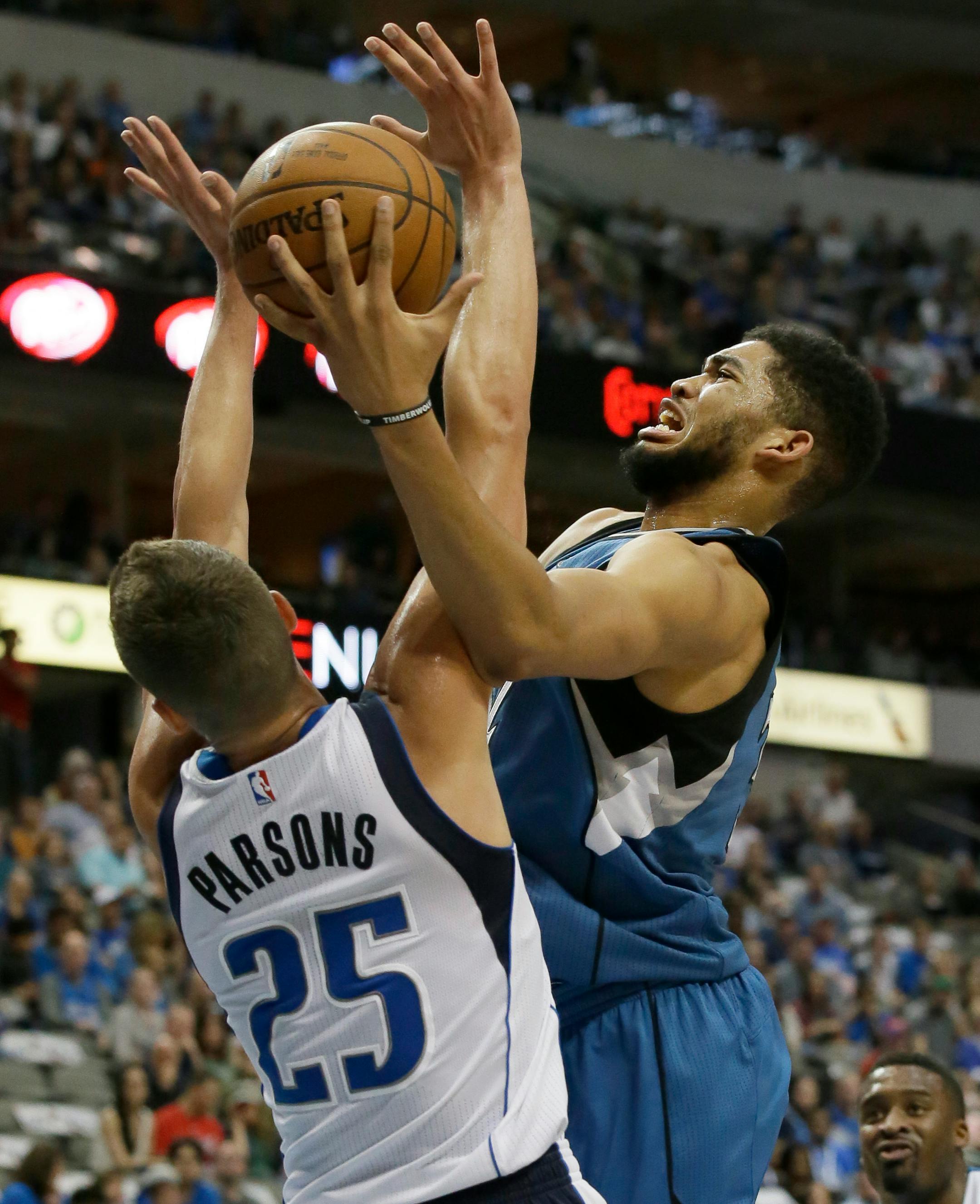 Minnesota Timberwolves center Karl-Anthony Towns, right, drivers against Dallas Mavericks forward Chandler Parsons (25) during the first half of an NBA basketball game Sunday, Feb. 28, 2016, in Dallas. (AP Photo/LM Otero)