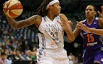 Lynx guard Seimone Augustus (33) looked for a teammate to pass to in the first quarter while defended by Phoenix Mercury forward Monique Currie (25) T