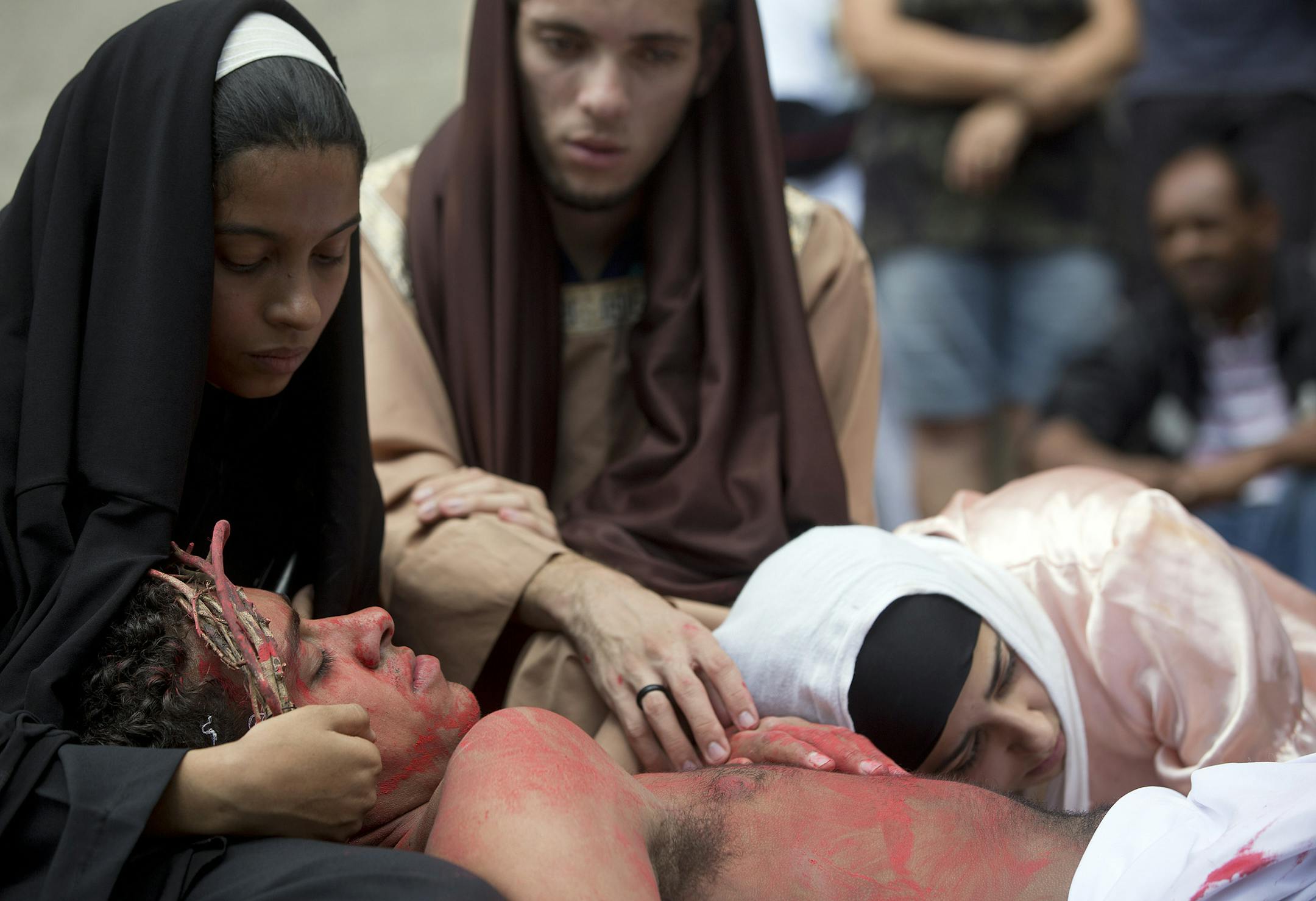 Church volunteers and homeless people reenact the journey of Jesus Christ's final hours, during a Good Friday procession, outside the city's cathedral in downtown Sao Paulo, Brazil, Friday, April 3, 2015. (AP Photo/Andre Penner)