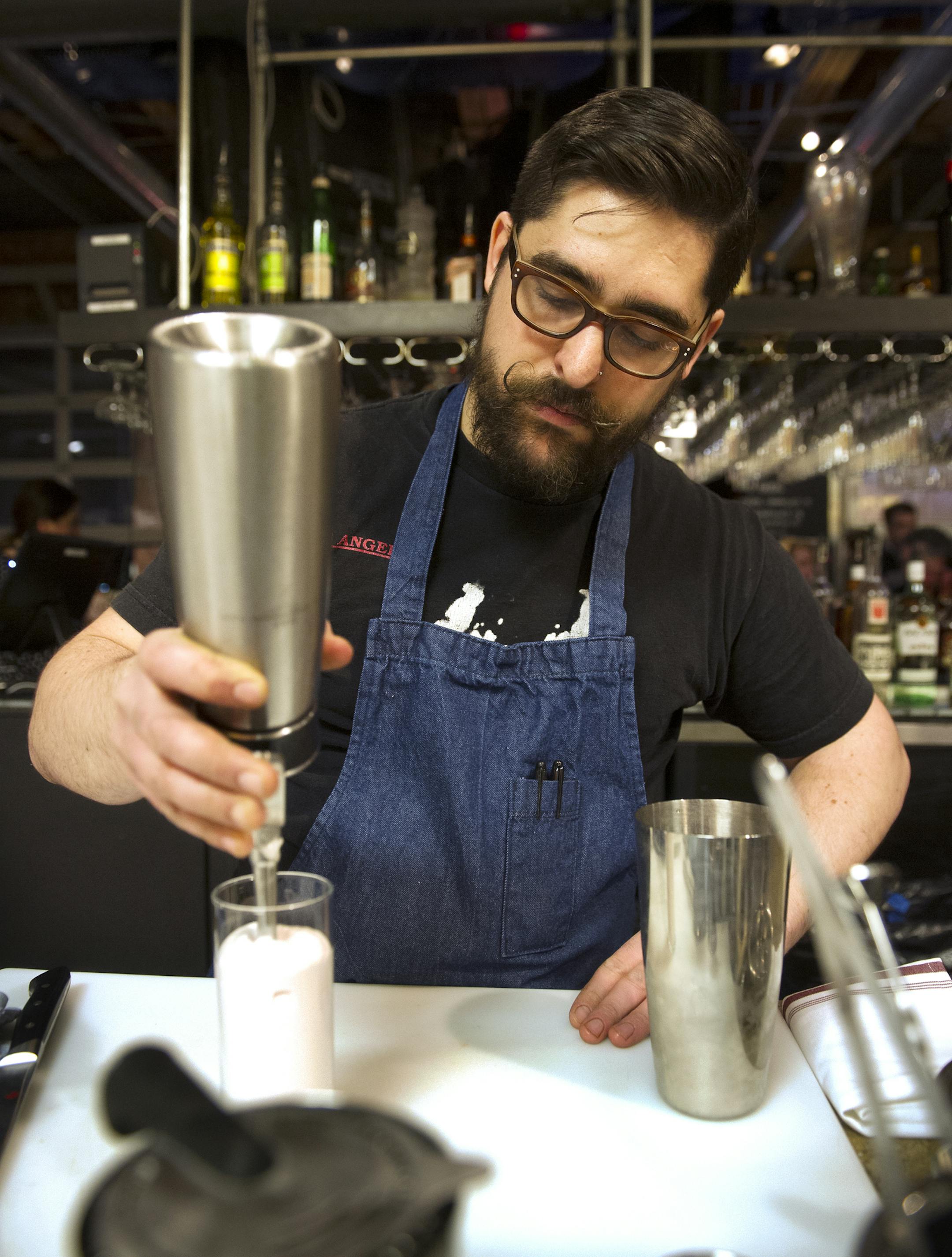 Abe Ziaimehr tops off a Jack Rabbit Slim cocktail with froth at the Rookery. (Matthew Hintz, 020714, Robbinsdale)