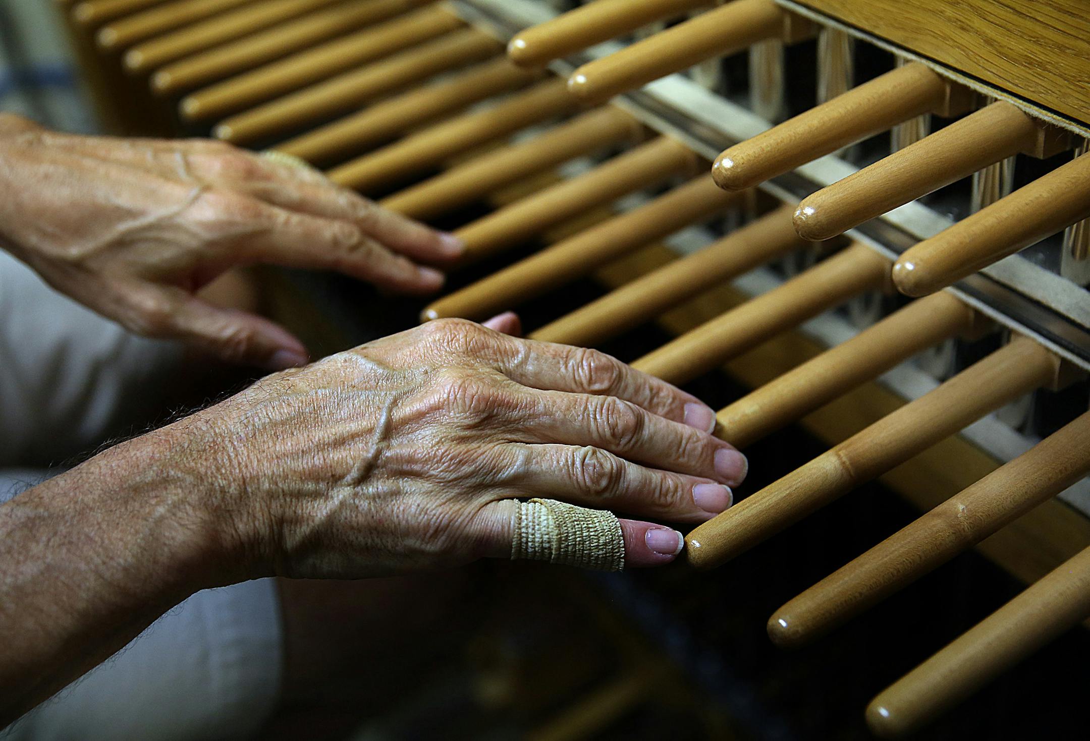 Mark Sedio recently played the carillon just beneath the bells, in the Central Lutheran Church bell tower. Sedio tapes some of his fingers to prevent blistering.