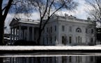 The White House is reflected in a puddle from the melting snow on Thursday, February 21, 2019 in Washington, D.C. (Olivier Douliery/Abaca Press/TNS)