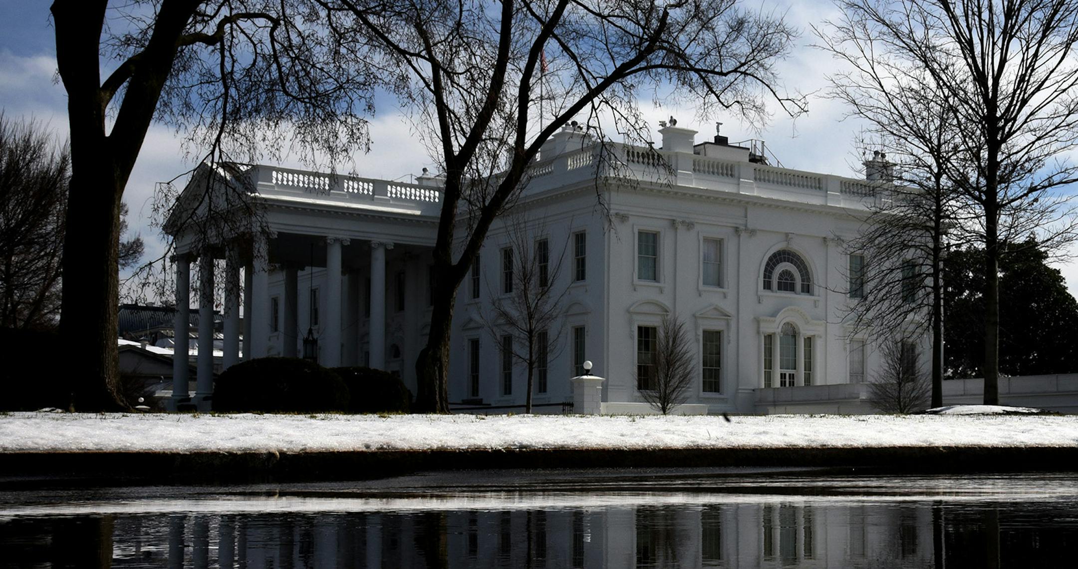 The White House is reflected in a puddle from the melting snow on Thursday, February 21, 2019 in Washington, D.C. (Olivier Douliery/Abaca Press/TNS)