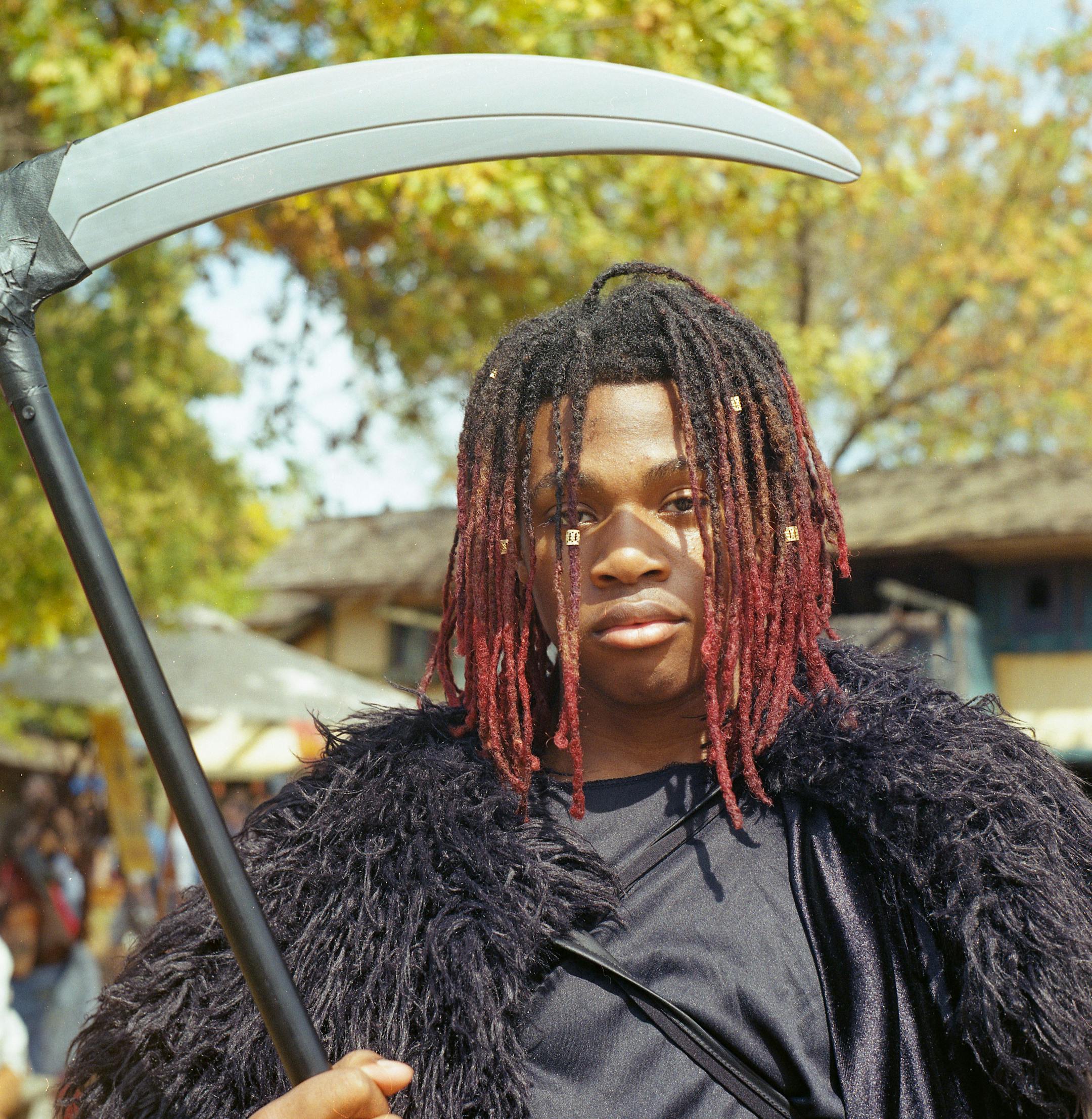 Deshawn Gardner poses for a portrait while dressed as the grim reaper. "People consider [dressing up in costumes] weird but if you go somewhere that everyone is weird, it's just normal," Gardner said.