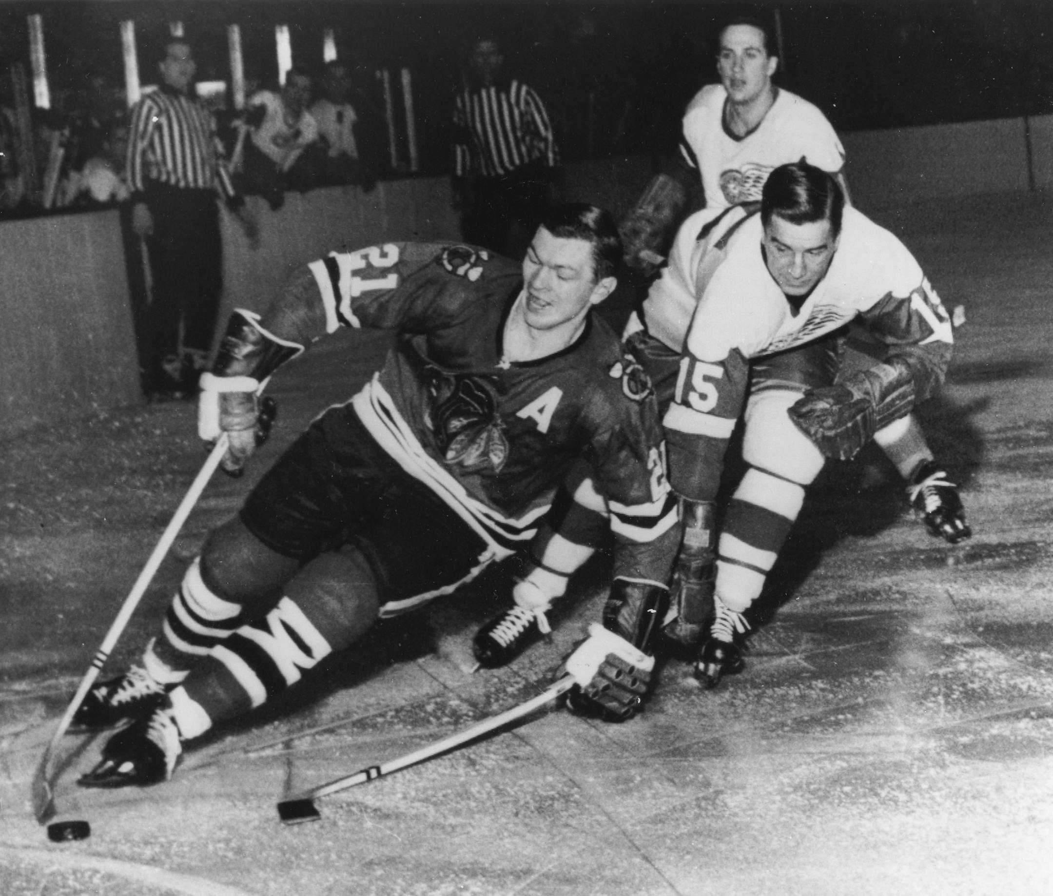 FILE - In this Feb. 24, 1965, file photo, Chicago Blackhawks' Stan Mikita,left, pulls away from Detroit Red Wings' Ted Lindsay during an NHL hockey game in Chicago. Mikita, who played for the Blackhawks for 22 seasons, becoming one of the franchise's most revered figures, has died, the Blackhawks announced Tuesday, Aug. 7, 2018. He was 78. (AP Photo/File)