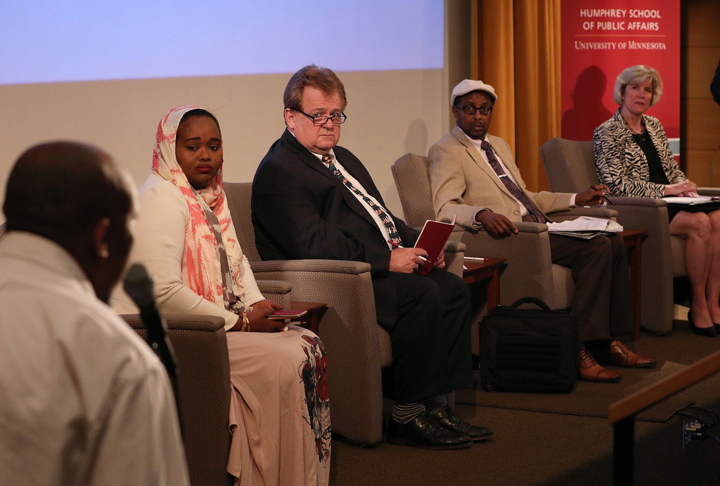 Abdirisak Jama, who has a child who he says didn't have autism until he was vaccinated, told his story and raised concerns to a panel of experts, including from left, Deeqa-Ifrah Hussein, Dr. Mark Schleiss, Dr. Mohamud Dahir Afgarshe, and Kristen Ehresmann, moderated by Vincent Makori, as they discussed vaccines and autism Saturday at the Cowles Auditorium in the Humphrey School of Public Affairs at the University of Minneapolis. ] ANTHONY SOUFFLE &#xef; anthony.souffle@startribune.com Vaccinati