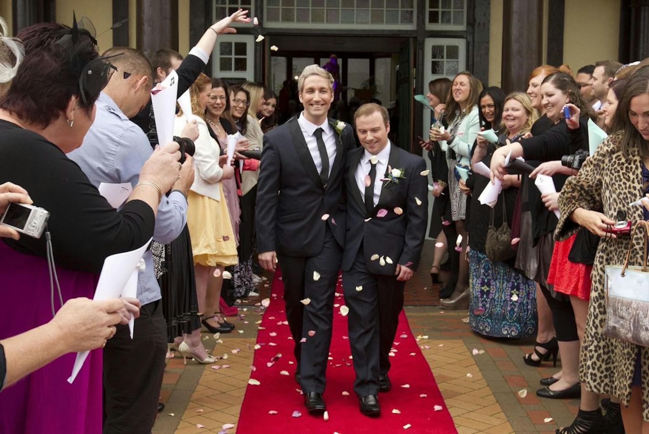Richard Andrew, center right, and Richard Rawstorn, center left, are showered in flower petals following their same-sex wedding ceremony held at Rotorua, New Zealand, Monday, Aug. 19, 2013.