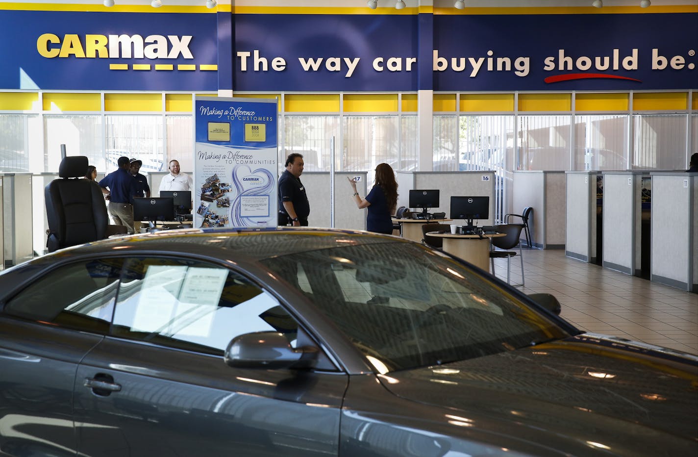 Customers shop for used vehicles inside the showroom of a CarMax Inc. dealership in Burbank, California, U.S., on Tuesday, June 17, 2014. CarMax Inc. is scheduled to release earnings figures on June 20. Photographer: Patrick T. Fallon/Bloomberg ORG XMIT: 498415701