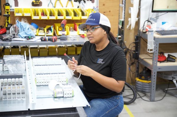 Kyla Sharp, an assembler of electronic control panels, sees her job as a career at growing Design Ready Controls in Brooklyn Park.
