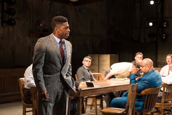 Curtis Bannister (standing) tries to sway his fellow jurors in Theater Latté Da's "Twelve Angry Men."