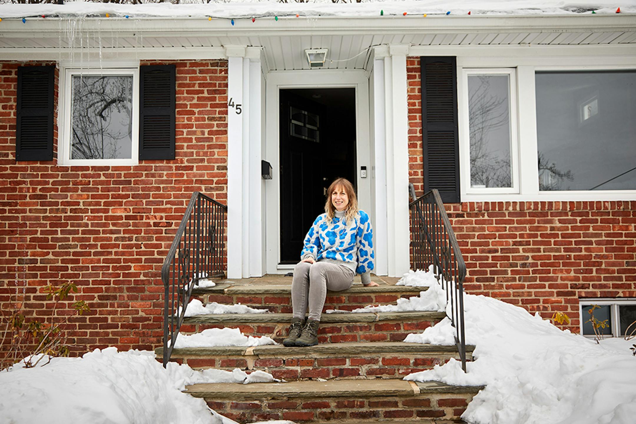 Jen Rondeau, who brightened a bland living room wall with a colorful mural, at her home in West Orange, N.J., Feb. 12, 2021. Since they have spent so much time at home in the last year, some homeowners have taken craft and design projects to a new level. (Laura Moss/The New York Times)