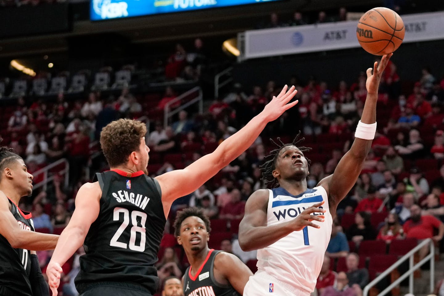 Minnesota Timberwolves forward Anthony Edwards, right, shoots as Houston Rockets center Alperen Sengun (28) defends during the first half of an NBA basketball game, Sunday, April 3, 2022, in Houston. (AP Photo/Eric Christian Smith)