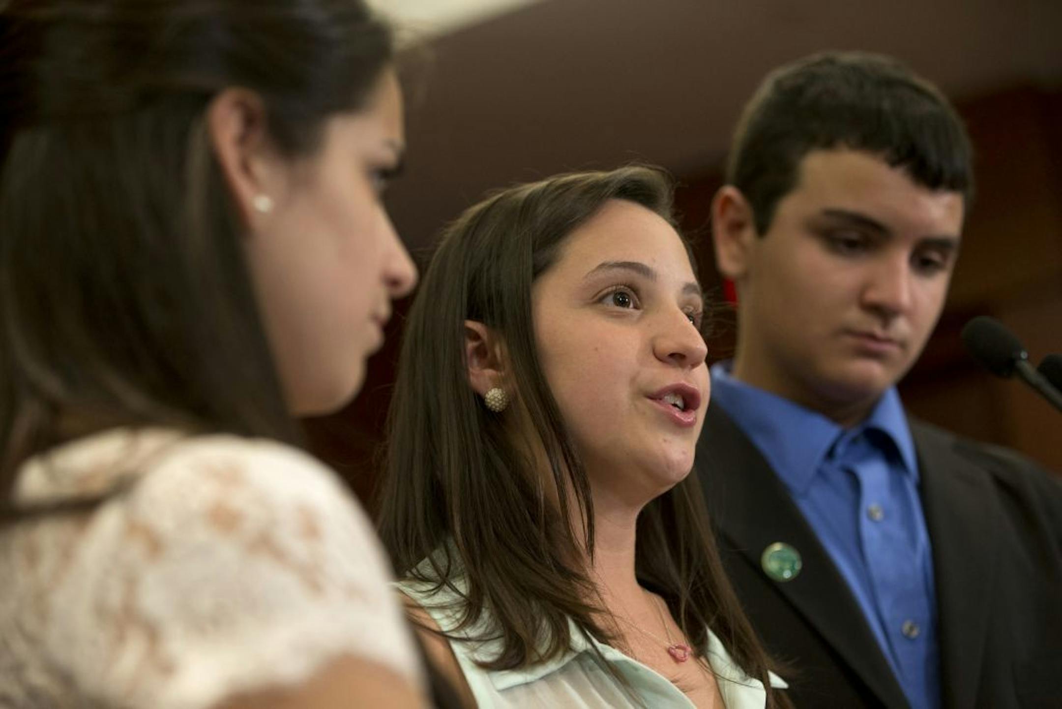 Jillian Soto, center, with siblings Carlee Soto, left and Carlos Soto, the siblings of Victoria Soto, speaks during a news conference on Capitol Hill in Washington, Thursday, June 13, 2013, on the sixth month anniversary of the Newtown, Conn. shootings.