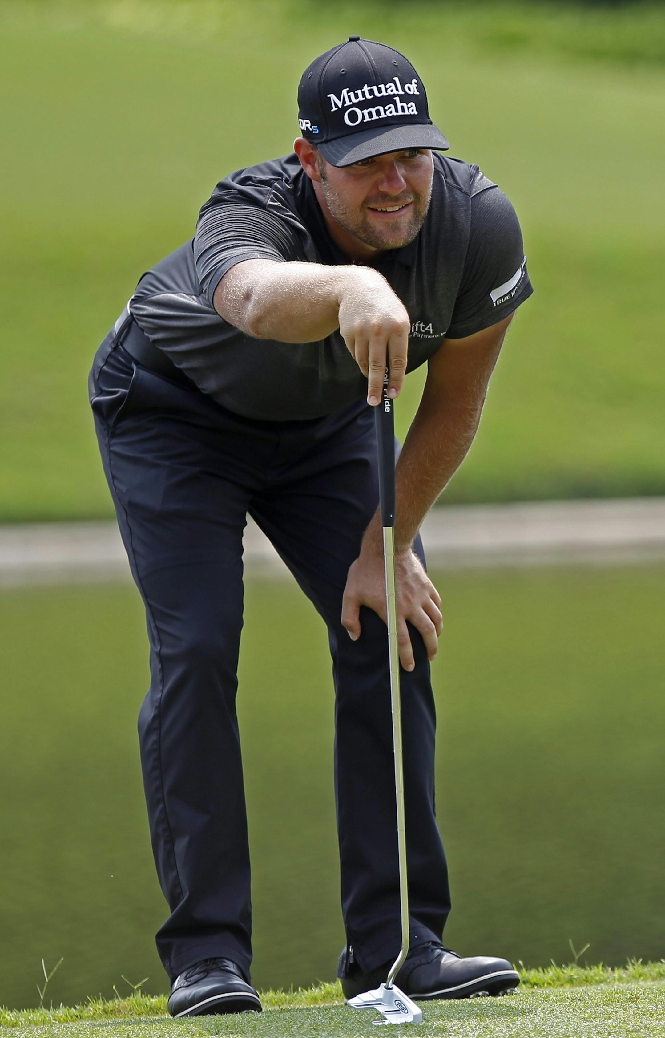 Ryan Moore of the United States lines up his putt on the 16th green during the final round of the CIMB Classic golf tournament at the Kuala Lumpur Golf and Country Club in Kuala Lumpur, Malaysia, Sunday, Nov. 2, 2014. (AP Photo/Lai Seng Sin) ORG XMIT: XKL121
