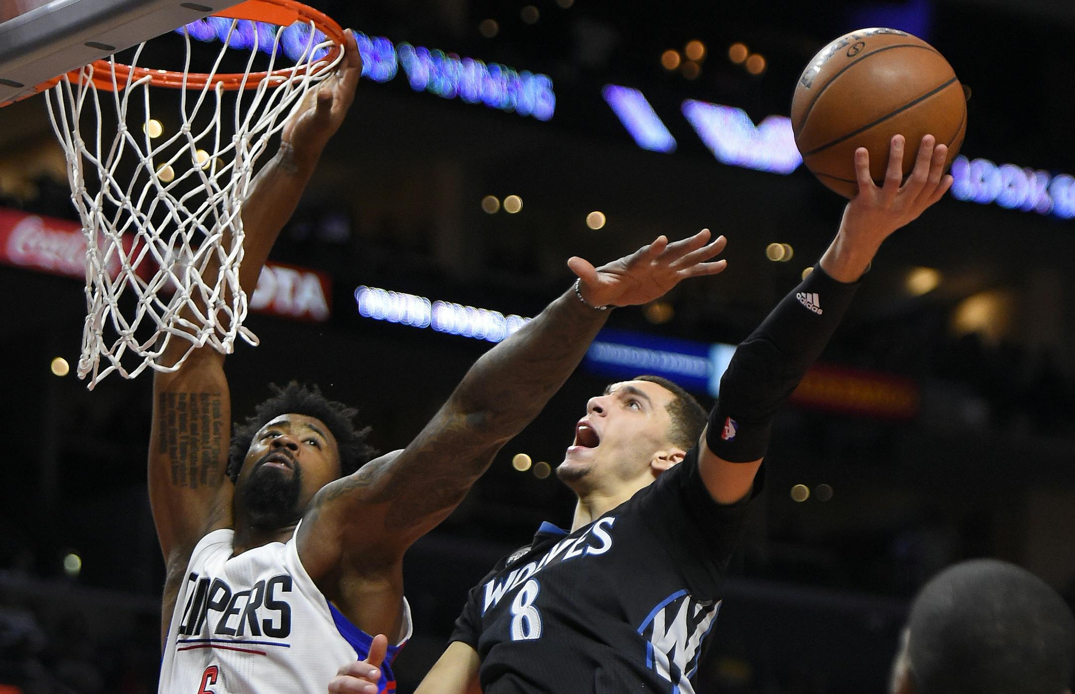 Minnesota Timberwolves guard Zach LaVine, right, shoots as Los Angeles Clippers center DeAndre Jordan defends during the second half of an NBA basketball game, Sunday, Nov. 29, 2015, in Los Angeles. The Clippers won 107-99. (AP Photo/Mark J. Terrill)