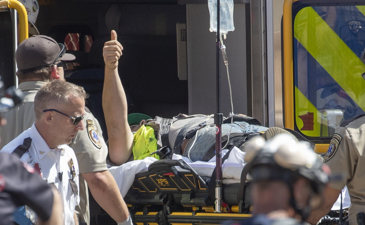 A construction worker gave a thumbs-up after being rescued by Minneapolis and St. Paul firefighters and a structural rescue team at a site on the corner of Park Street and Washington Avenue, Monday, July 29, 2019 in Minneapolis, MN. ] ELIZABETH FLORES &#x2022; liz.flores@startribune.com