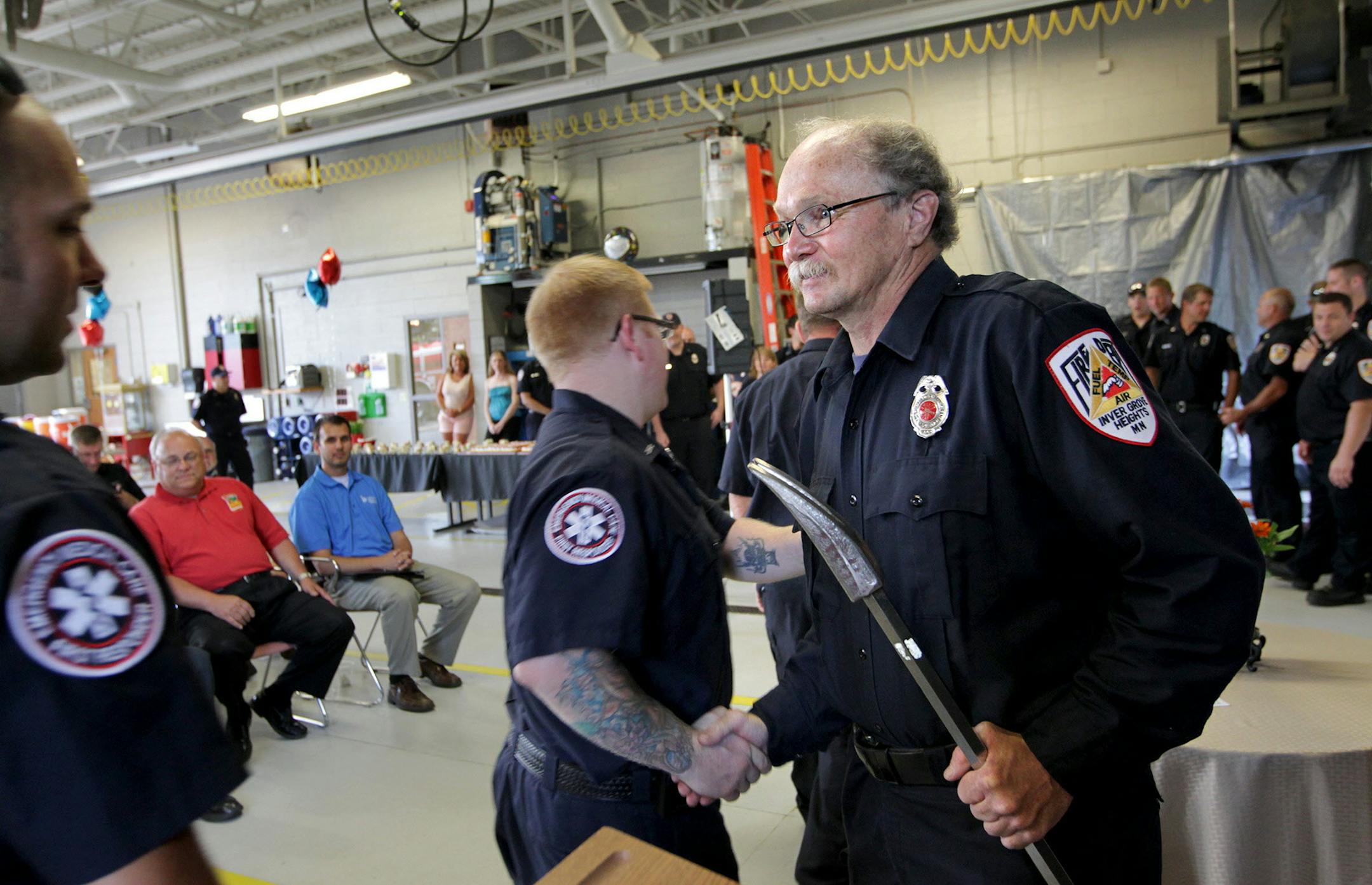 Firefighters line up to shake the hand of Jeff Davis after he received multiple awards in honor of 40 years of exemplary service as a paid-on-call volunteer firefighter at Fire Station 3 in Inver Grove Heights July 14, 2013. Davis, who just completed his 33rd Grandma's Marathon, has no plans yet to quit being a firefighter. (Courtney Perry/Special to the Star Tribune)
